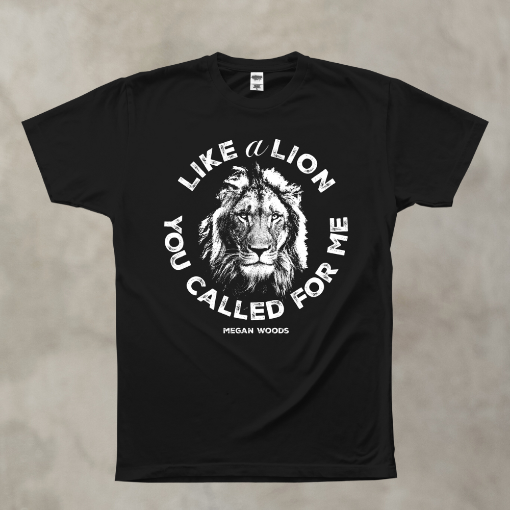 Black t-shirt with lion graphic and text on a beige background